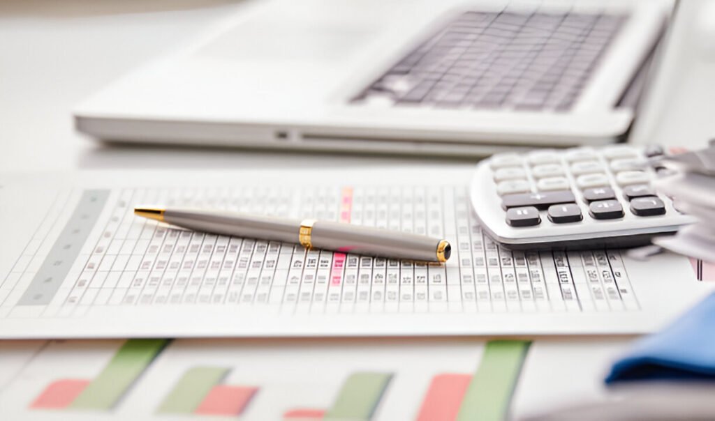 Close-up of financial figures with a calculator and a pen, illustrating financial management
