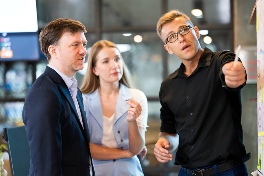 How to Create a Business Operations Strategy That Scales 1 Collaboration Strategies to Improve Teamwork in Your Business Goal. Shot of a group of Business Management team having brainstorming on project task with notes on a board in a financial business office, illustrating how to create a business operations strategy